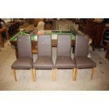 A set of four faux leather high back dining chairs