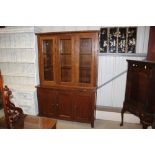 A G-plan oak bookcase on cupboard