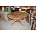 A 19th Century rosewood centre table, raised on tr