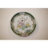 An oriental famille verte plate decorated figures
