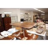 A Regency mahogany snap top supper table on quatre