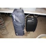 A travel cot; and a hard cased suitcase
