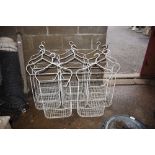 Eleven wrought metal and wirework hanging planters