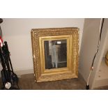 A 19th Century gilt framed wall mirror with ribbon