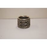 An oriental white metal archers ring