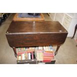 An antique oak drop leaf dining table with single