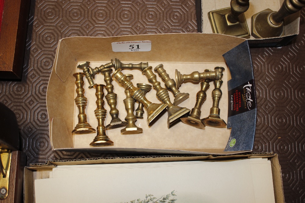 A collection of miniature brass candlesticks