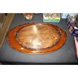 A 19th Century mahogany oval two handled tray; and