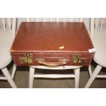 A small vintage leather suitcase