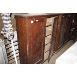 A late Victorian pitch pine storage cupboard