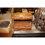 A small mahogany table top nest of drawers