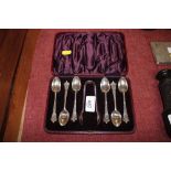 A cased set of six plated teaspoons and sugar tong