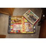 A box containing various vintage jigsaw puzzles