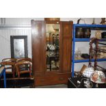 An Edwardian oak and inlaid mirror door wardrobe (