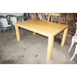 A large light oak effect kitchen table
