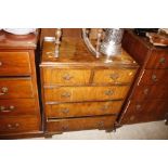 A walnut chest of two short and three long drawers