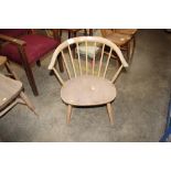 An Ercol style stick back, tub shaped low chair