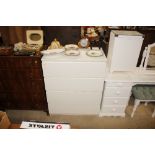 A white laminate chest of four drawers