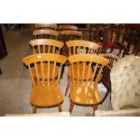 A set of four slat back kitchen chairs