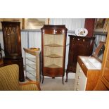 An Edwardian inlaid mahogany corner cupboard