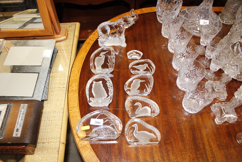 Various decorative glass paperweights; and a glass elep