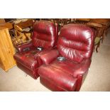 A pair of leather electric reclining armchairs