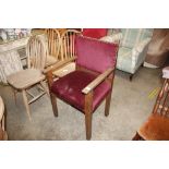 An 1930's oak elbow chair with upholstered seat an