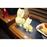 A set of three graduated Sylvac yellow rabbits