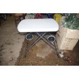 A plastic and metal folding garden table