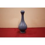 A small blue glazed onion topped vase