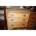 A stripped pine chest fitted three drawers