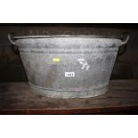 A galvanised twin handled tub