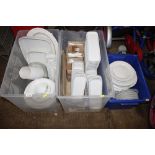 Three plastic crates containing white glazed china