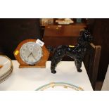 A Smiths alarm clock; and a china model of a poodl