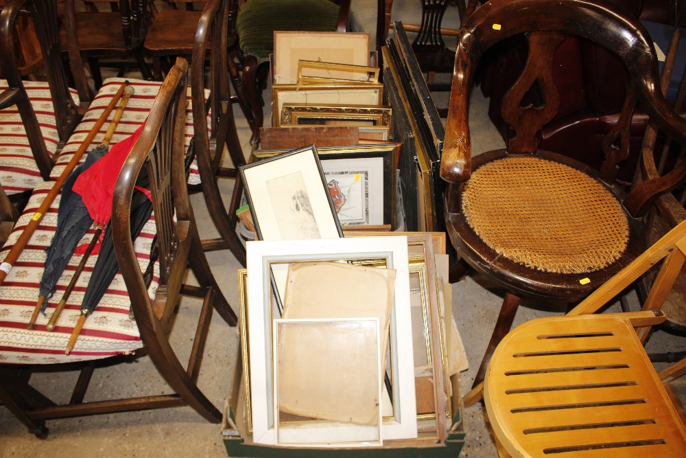 A large collection of various picture frames and prints
