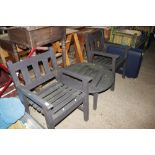 A pair of teak garden chairs and circular slatted