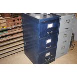 A metal three drawer filing cabinet