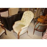 A Victorian button back upholstered armchair