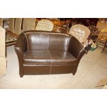 A leatherette upholstered two seater settee