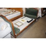 A French green upholstered walnut single bed and c