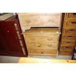 A stripped pine chest of three drawers