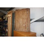 An antique stripped pine hanging corner cupboard