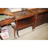 A polished wood two tier tea trolley