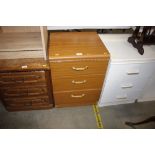 A laminate three drawer bedside chest