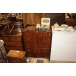 A walnut chest of five graduated drawers