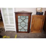 A Georgian oak hanging corner display cabinet