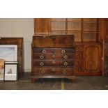 A George III mahogany bureau fitted two short and