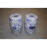 A pair of blue and white oriental style barrel sto