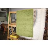 A green wool rug, approx. 5' x 2'8"
