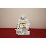 A cast iron model of the Michelin Man and dog